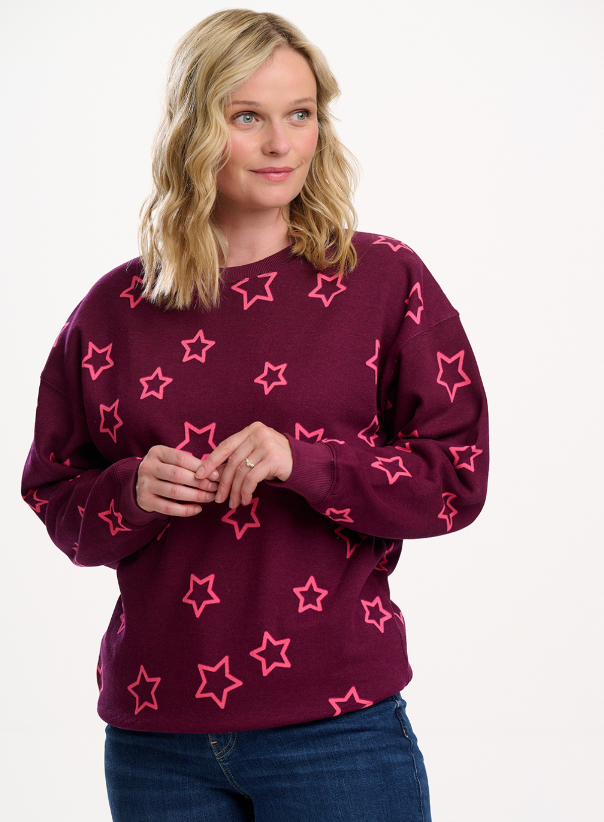 Woman wearing the Sugarhill Brighton Eadie Burgundy Spaced Out Stars Relaxed Sweatshirt on a white background