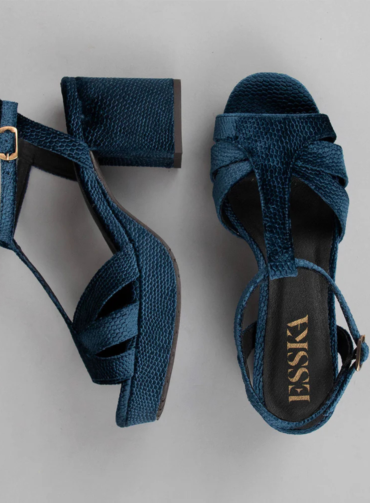 Pair of Esska Charlie Blue Velvet T Bar Heels on a grey background. Side and overhead shot showcasing the block heel and round open toe shape of these block heel sandals.