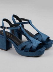 Pair of Esska Charlie Blue Velvet T Bar Heels against a grey background. Close up front side shot showcasing the block heel with embossed velvet lizard pattern and the t bar straps.