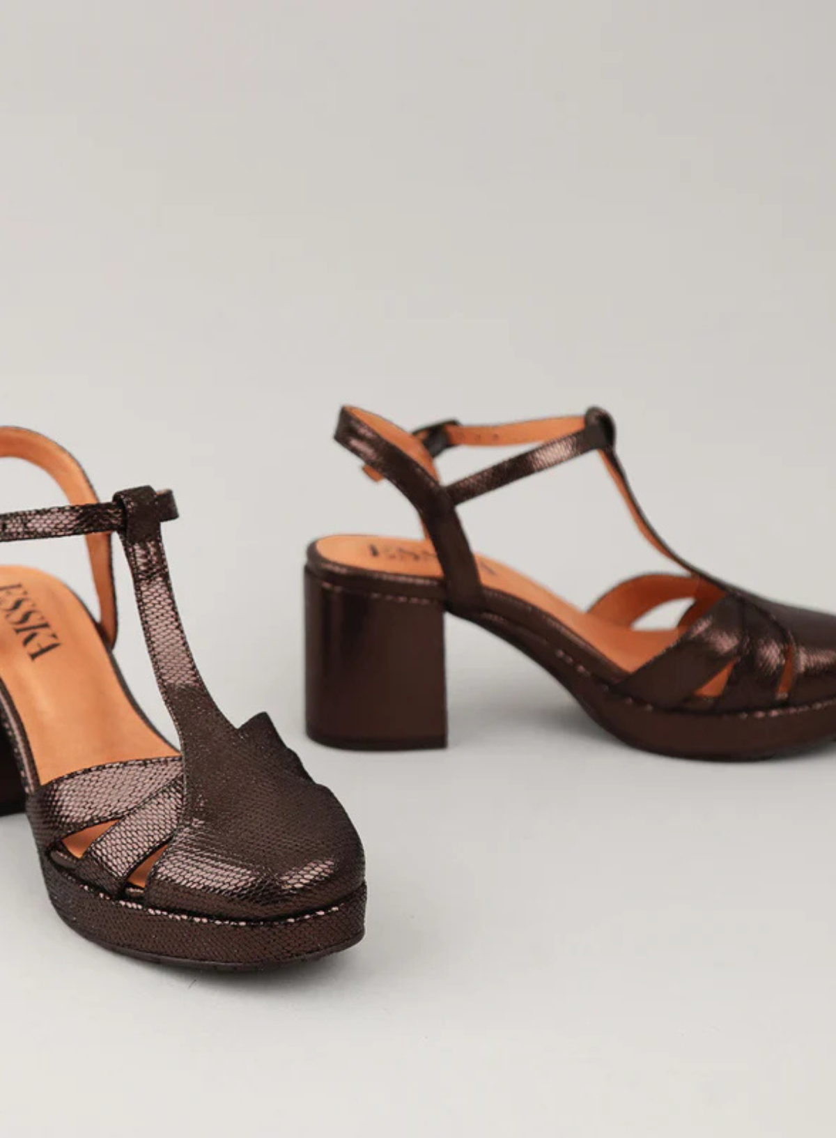 Pair of Esska Celeste Dark Brown Metallic Platform Block Heels against a grey background. Front and side shot showcasing the metallic appearance, the straps and block heel.