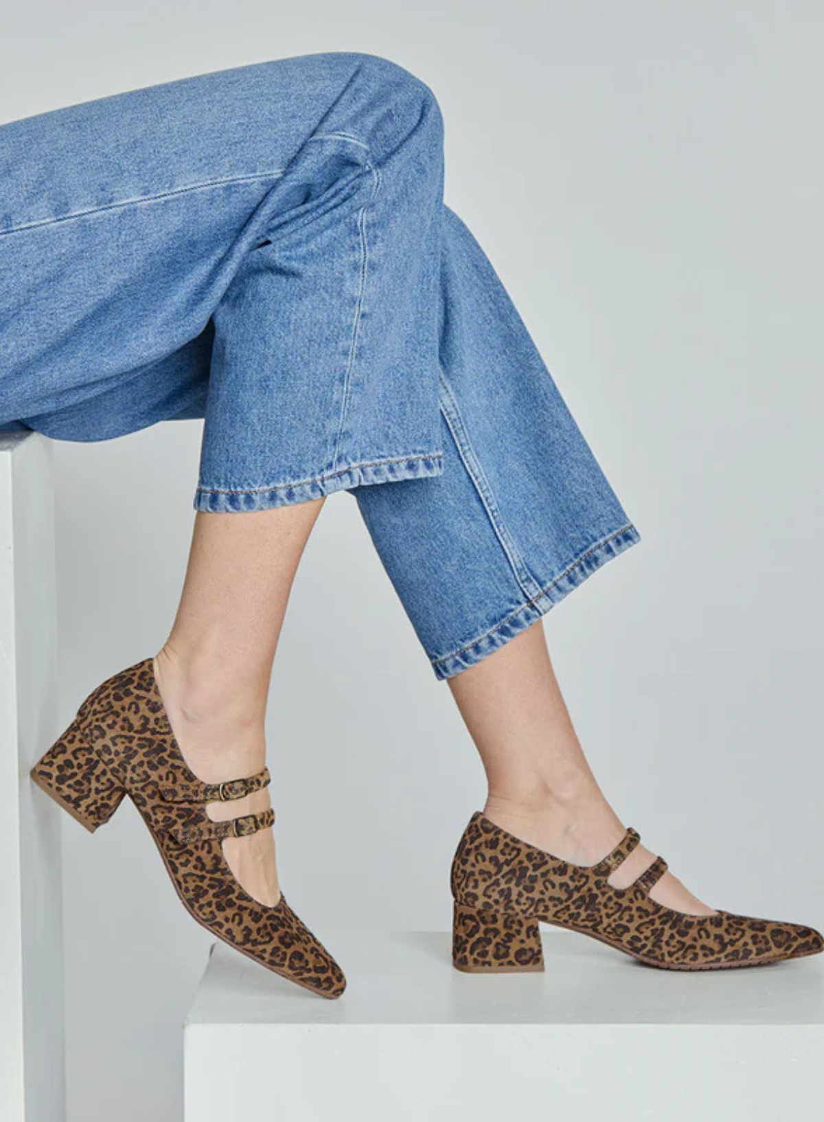 Model wearing the Esska Laura Low Leopard Heels and cropped jeans in side profile showcasing the block heel and leopard print.
