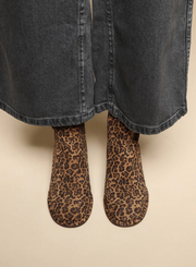 Model wearing the Esska Mona Leopard Print Boots with wide leg charcoal jeans. Front shot showcasing the all over leopard print and round toe shape of these leopard print ankle boots.